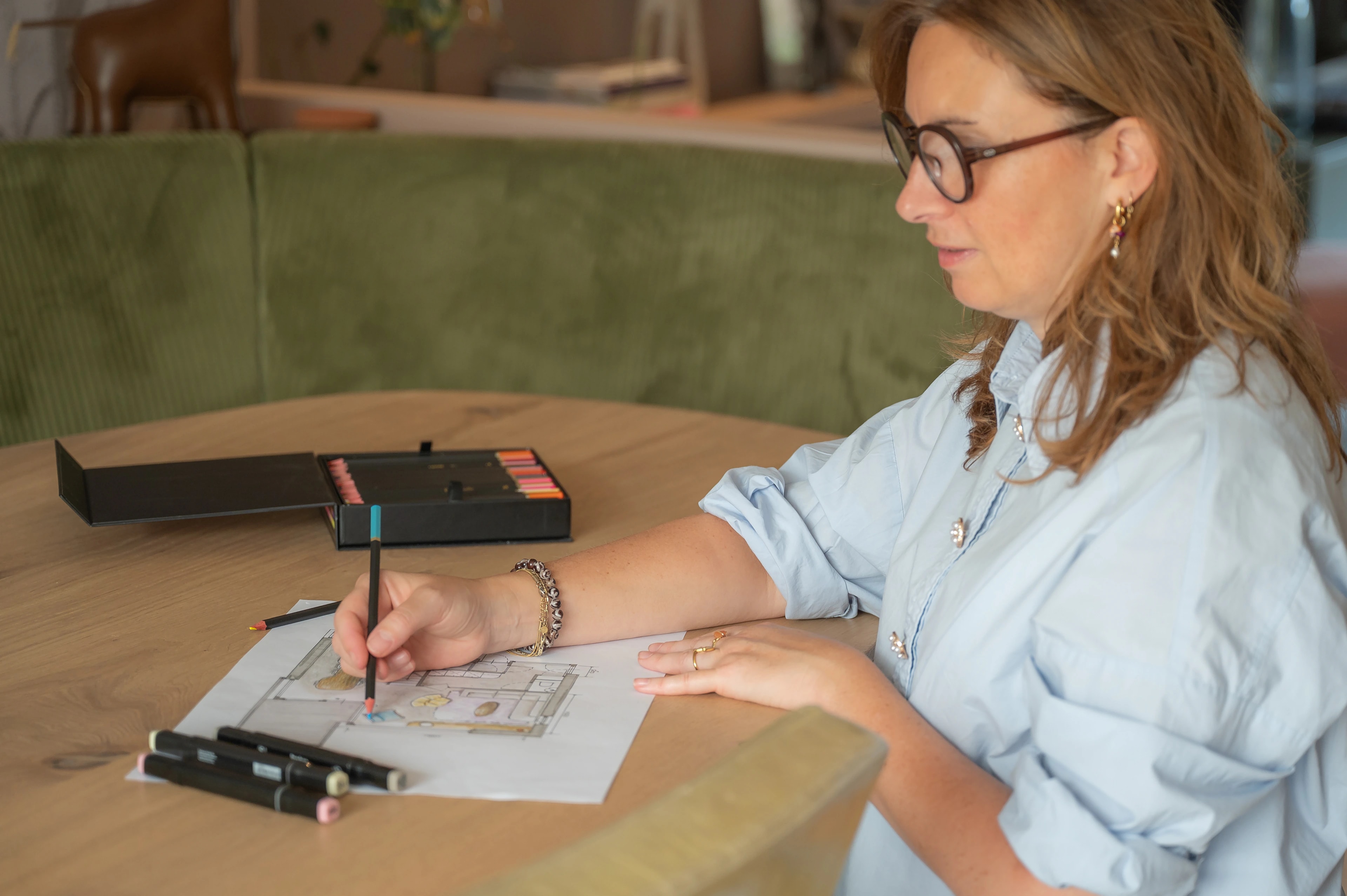 Linda werkt aan een interieurontwerp aan tafel